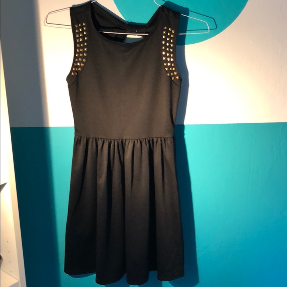 Black babydoll dress with gold stud accents